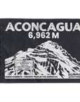 A rectangular black summit flag featuring a white illustrated mountain scene with the text 'ACONCAGUA 6,962 M' and smaller text reading 'SEVEN SUMMITS - HIGHEST PEAK IN THE AMERICAS' and 'SUMMIT SOMETHING'.