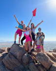 Summit Photo displaying hikers celebrating reaching Camelback Mountain summit with a 5ummit 5omething summit flag.