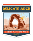 Sticker depicting the majestic Delicate Arch in Arches National Park.  Artwork on the sticker reads Delicate Arch at the top and Arches National Park at the bottom.  Scenery is beautiful capturing the reddish brown colors of the lanscape with mountains and setting sun in the background.