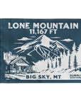 A navy summit flag depicting the classic  dramatic view of Lone Mountain and with Lone Mountain and elevation of in white text the name of Lone Mountain and the 11,167 elevation written in white text at the top and Big Sky, MT written at the bottom.